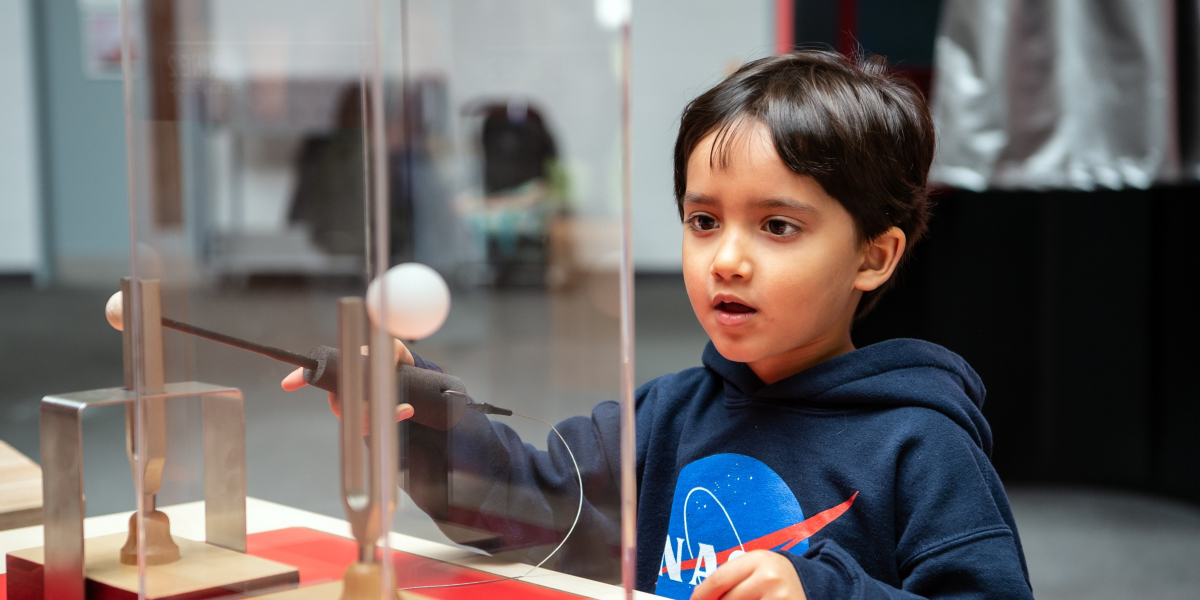 Child exploring a hands-on exhibit at Winchester Science Centre